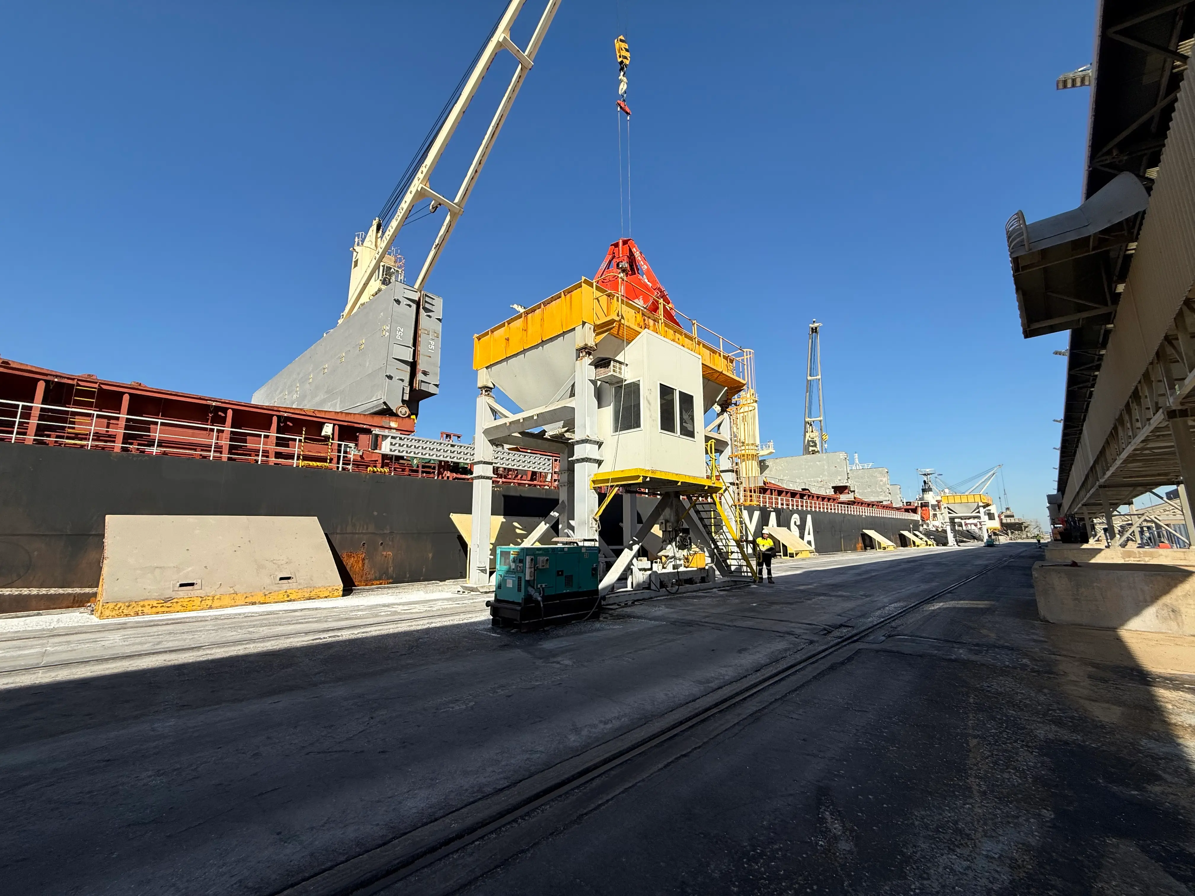 Bulk vessel discharging into a hopper at the Geelong berth under a clear sky